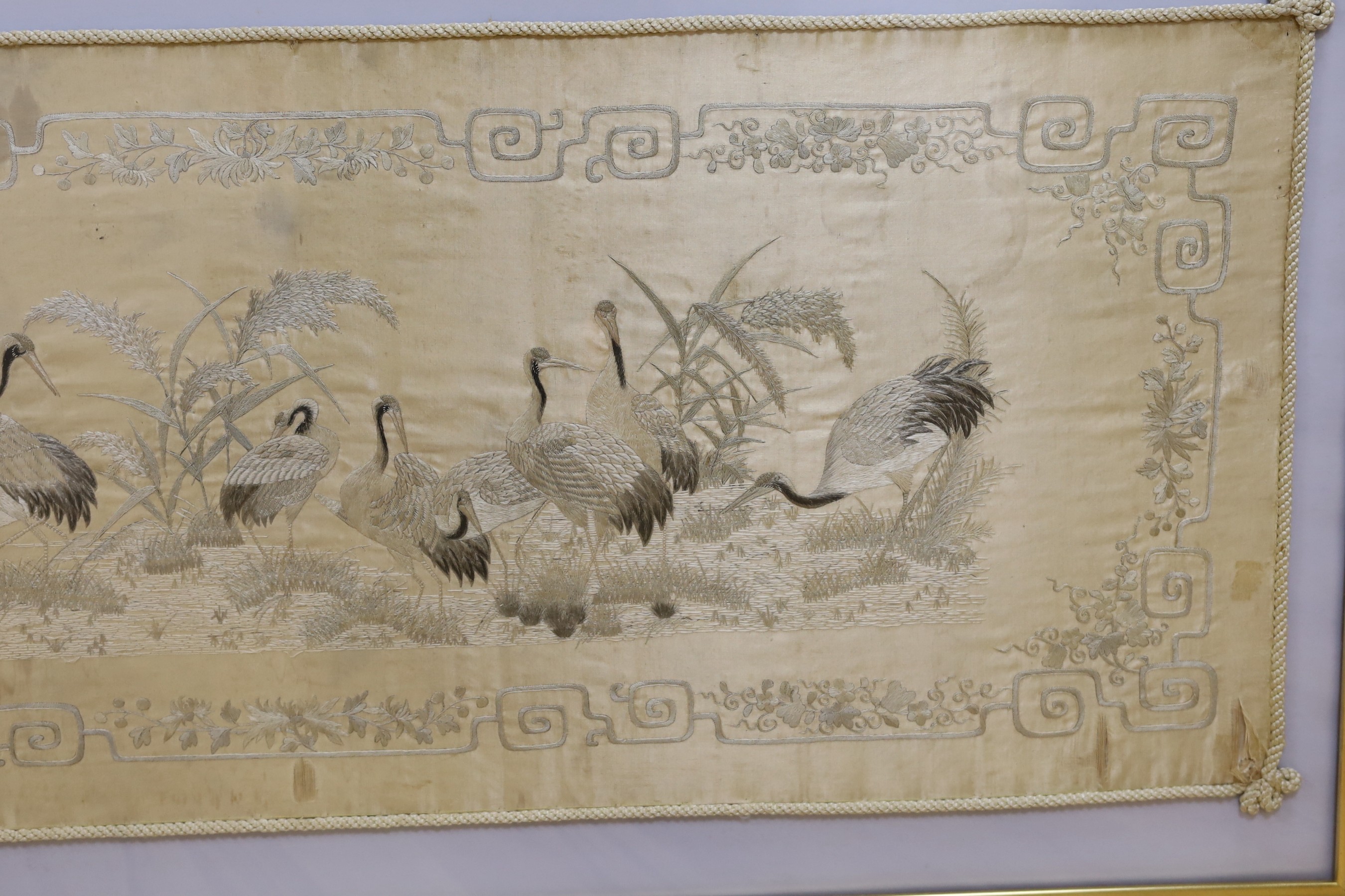 A Japanese silkwork panel, 39cm x 122cm